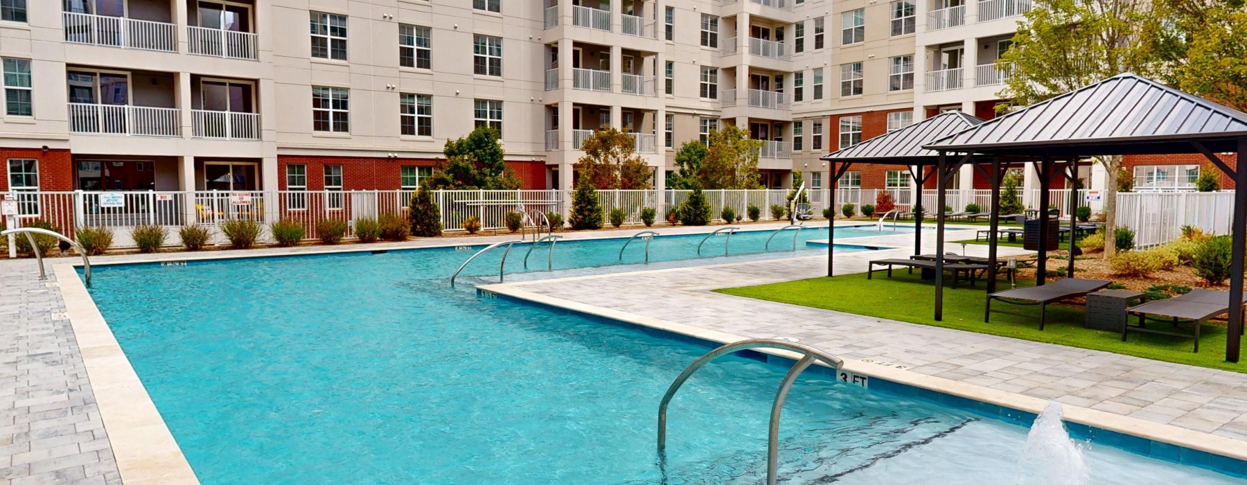 a swimming pool with lounge chairs